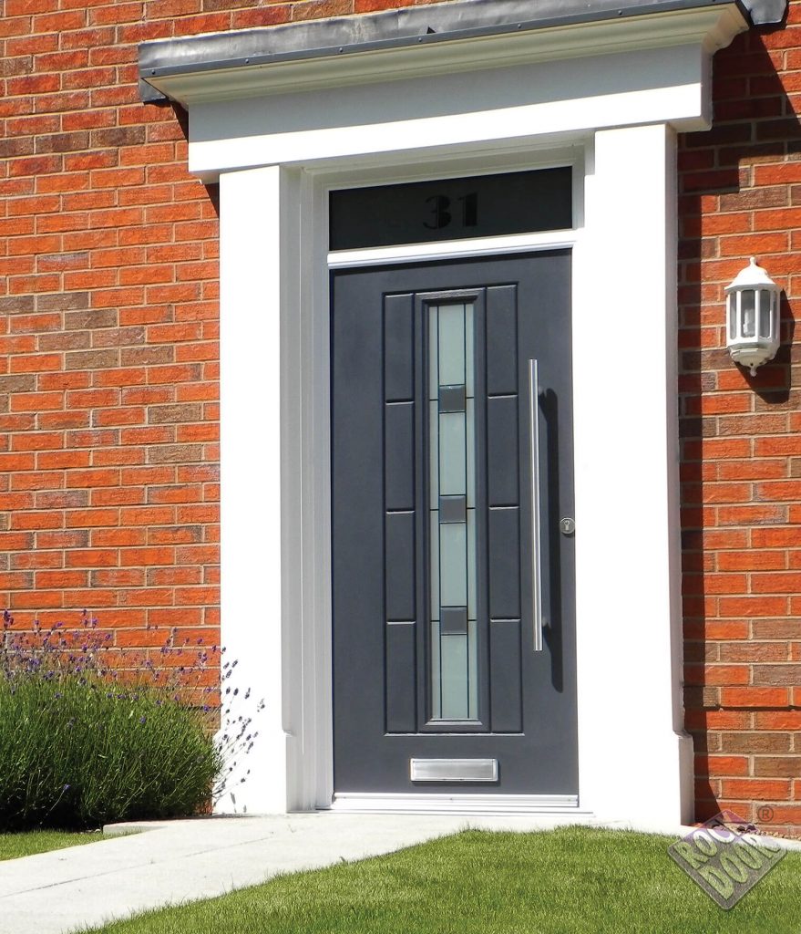 Vermonth Grey rockdoor composite door on a brick house.