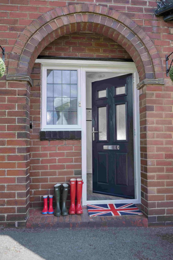 Open black residor composite door with sidelight.